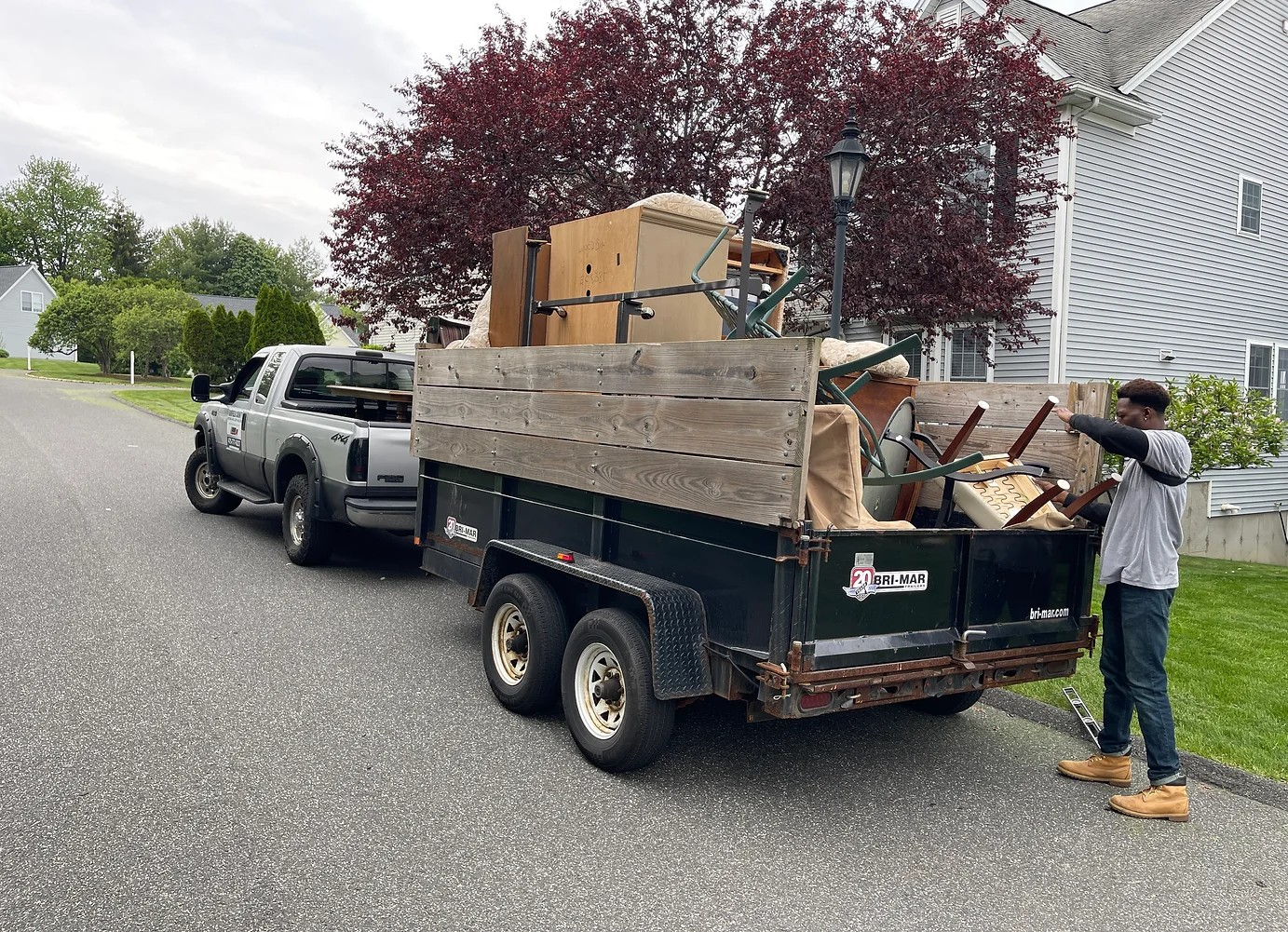 a member of Pro Movers standing next to a junk removal truck for junk and old furniture