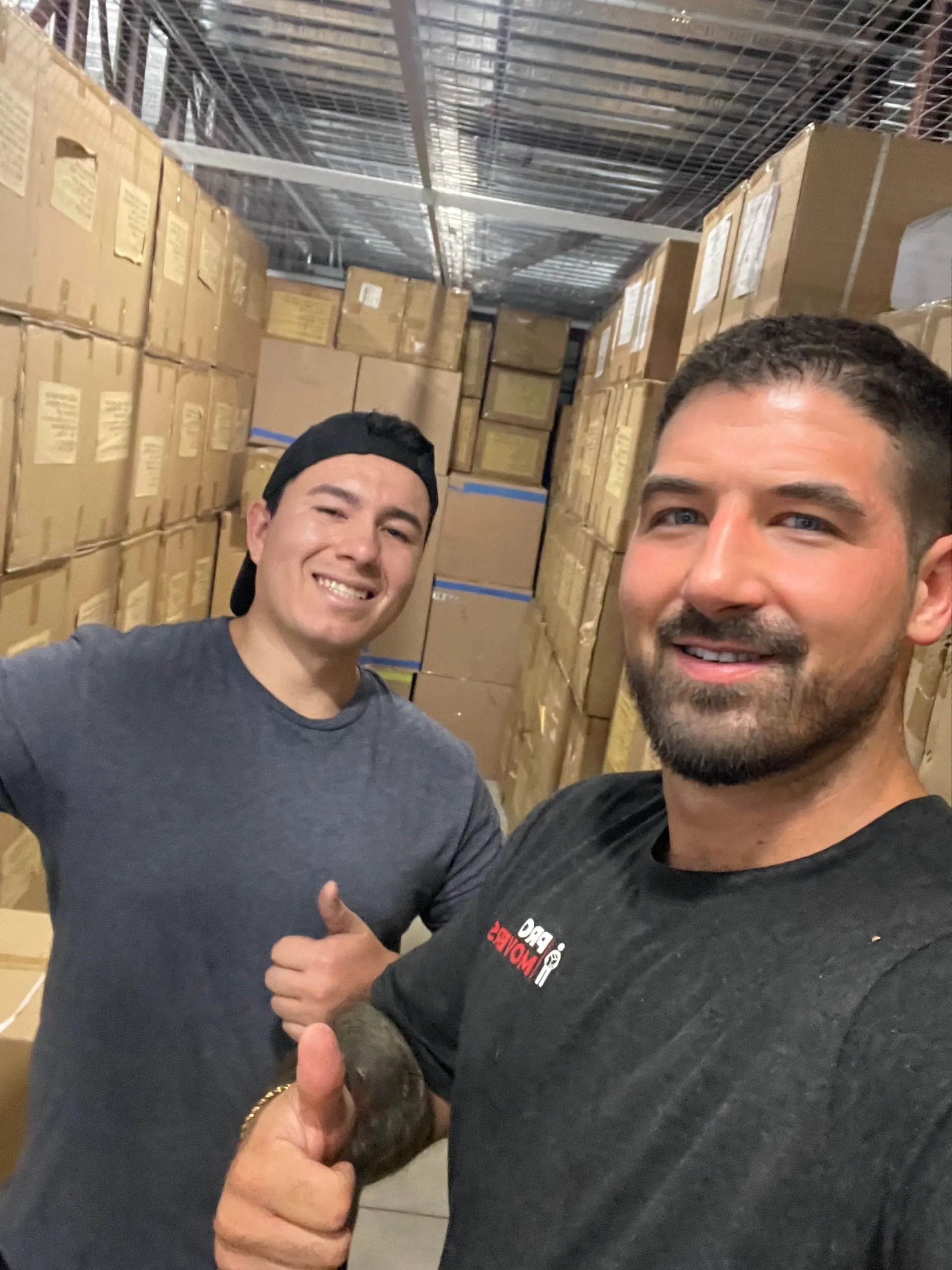 Pro Movers - a licensed and praised moving company you can trust the founders of Pro Movers in a storage facility